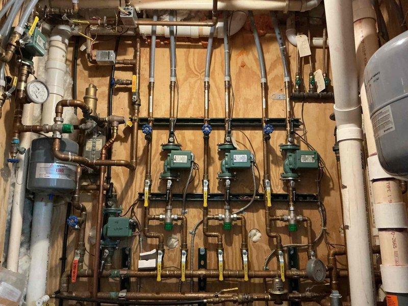 Responded to client's report of partial heat issue with boiler system that serves in-floor radiant heating. Inspected the zoned hydronic system with multiple Taco circulators mounted on plywood backing, verifying thermostat function for two problematic zones. Confirmed both thermostats properly engage their respective pumps and that supply/return lines feel warm when called. Due to complexity of the multi-zone installation with numerous valves and copper distribution piping, scheduled follow-up visit with senior technician for further diagnosis as immediate cause of inadequate heating in upstairs bedrooms could not be determined.