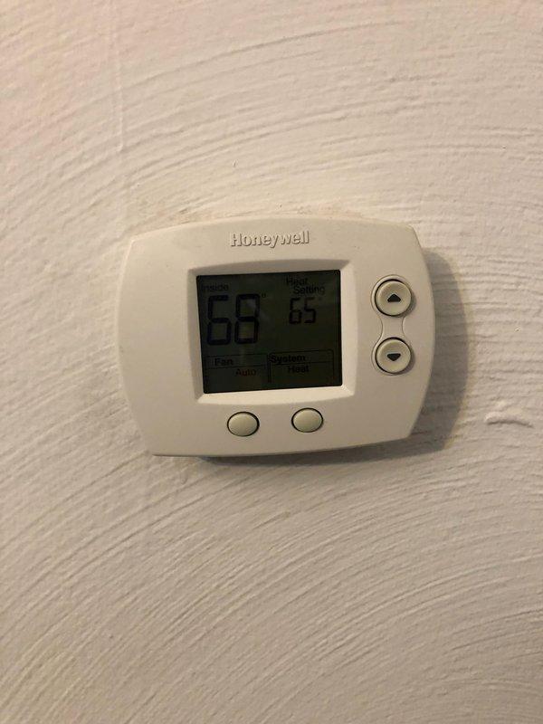 Performed comprehensive furnace tune-up on 10-year-old Guardian furnace (2009 model) that had not been serviced in 8 years. Inspected and verified all components including heat exchanger, finding everything functioning properly to specification despite notable accumulation of cat litter dust around the unit. Thermostat and Aprilaire humidifier system were confirmed operational with heating system set appropriately for the season.