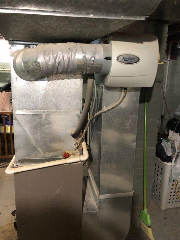 Performed comprehensive furnace tune-up on 10-year-old Guardian furnace (2009 model) that had not been serviced in 8 years. Inspected and verified all components including heat exchanger, finding everything functioning properly to specification despite notable accumulation of cat litter dust around the unit. Thermostat and Aprilaire humidifier system were confirmed operational with heating system set appropriately for the season.