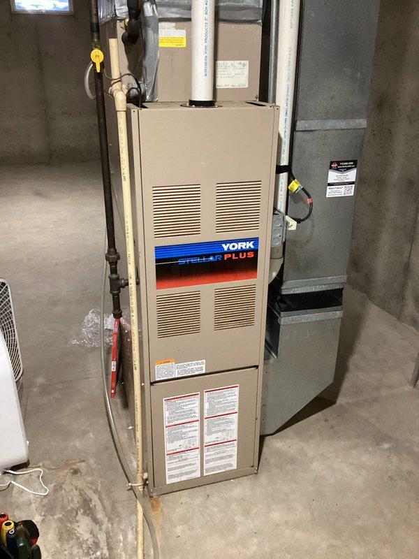 Performed diagnostic inspection on 30-year-old York Stellar Plus furnace that was intermittently failing to heat. Conducted complete system tuneup, cleaned heavily corroded flame sensor, and verified proper condensate drainage. Inspection of exterior venting identified potential airflow restrictions from a bush obstructing the exhaust vent and improper intake/exhaust configuration that could cause exhaust recirculation. Advised homeowner to remove obstructing vegetation and recommended modification of intake vent height to prevent exhaust gas reentry.
