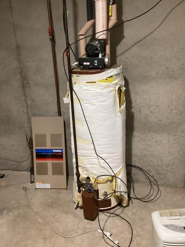 Performed diagnostic inspection on 30-year-old York Stellar Plus furnace that was intermittently failing to heat. Conducted complete system tuneup, cleaned heavily corroded flame sensor, and verified proper condensate drainage. Inspection of exterior venting identified potential airflow restrictions from a bush obstructing the exhaust vent and improper intake/exhaust configuration that could cause exhaust recirculation. Advised homeowner to remove obstructing vegetation and recommended modification of intake vent height to prevent exhaust gas reentry.