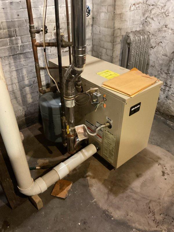 Performed annual tune-up on 2003 high-efficiency boiler which is in generally good condition. Inspection revealed system requires new HSI, lacks proper air elimination, and has an inaccurate pressure/temperature gauge. Recommended complete radiator system flush, drain and treatment along with installation of missing components to bring system to proper specifications.