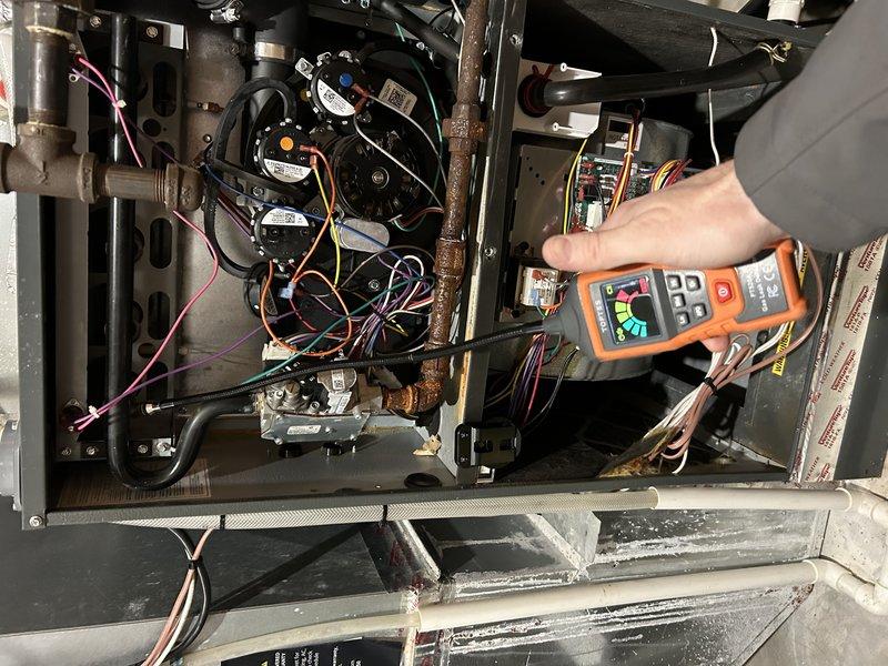 Responded to call for gas odor in 8-12 NG furnace, which customer reported was stronger when unit was inactive. Upon diagnostic testing with multimeter, determined gas valve was bypassing and allowing gas to leak through burners during off-cycle. Replaced defective gas valve under warranty to resolve the safety hazard.