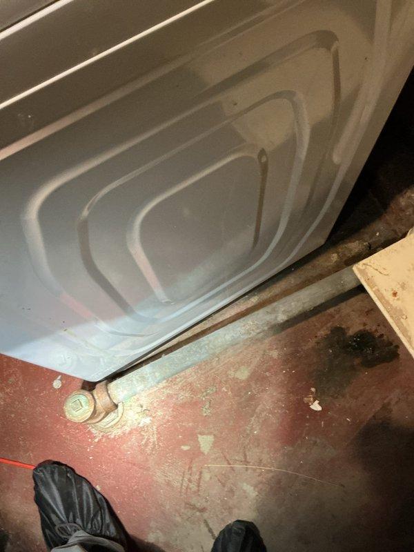 Responded to service call for active washing machine drain leak. Discovered galvanized plumbing was plugged, shut-off valves were non-functional, and tub drain required repair. Completed full replacement of galvanized piping with new PVC drainage system, installed new shut-off valves, and replaced tub drain to restore proper functionality.