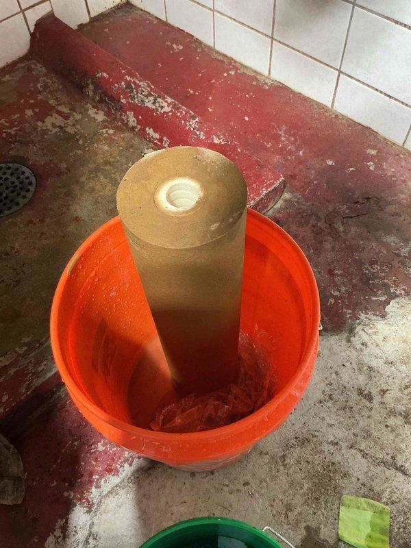 Performed annual service on customer's water treatment system, replacing the iron filter cartridge in the VIQUA filtration unit. Removed old iron filter media, properly disposed of waste material, and installed new filter. System functioning properly after service completion.