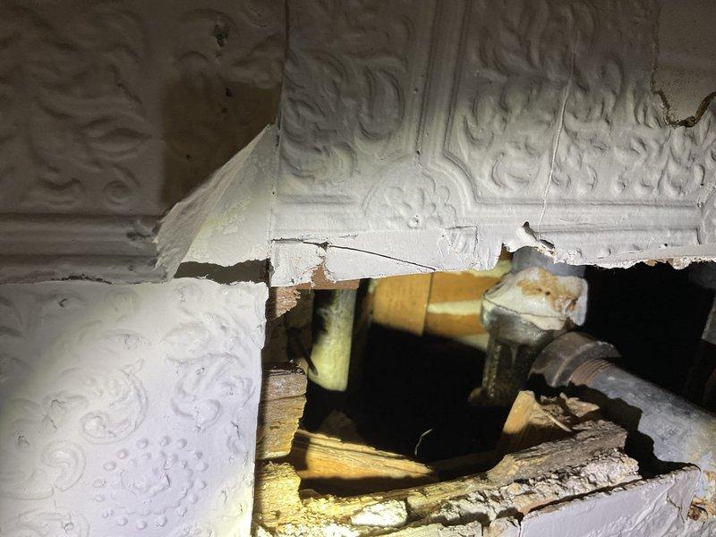 Diagnosed and resolved two bathroom sink issues: removed water bottle cap causing clog in main floor sink drain assembly, and replaced damaged components on second floor sink by installing new PVC sanitary tee, p-trap, and drain piping. Addressed leak-related ceiling damage likely caused by improper winterization of the home. Both sinks tested and confirmed fully operational after repairs.