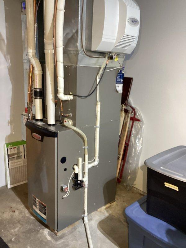 Performed comprehensive tune-up service on a three-year-old gas furnace. Inspection included heat exchanger examination, condensate drain cleaning, and flame sensor maintenance. System operation verified with all components functioning properly; no issues detected. Unit appears well-installed with proper piping configuration and auxiliary humidifier integration.