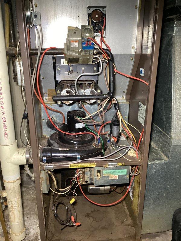Performed scheduled furnace tune-up on 1983 model. System running but exhibiting short cycling after approximately 5 minutes due to limit switch activation. Diagnostics revealed severely plugged secondary heat exchanger, dirty blower wheel with worn bearings, and oversized blower motor capacitor (7.5μF rated, measuring 9.1μF). Recommended system evaluation by advisor before proceeding with necessary repairs including blower wheel cleaning, secondary heat exchanger cleaning, and blower motor replacement.