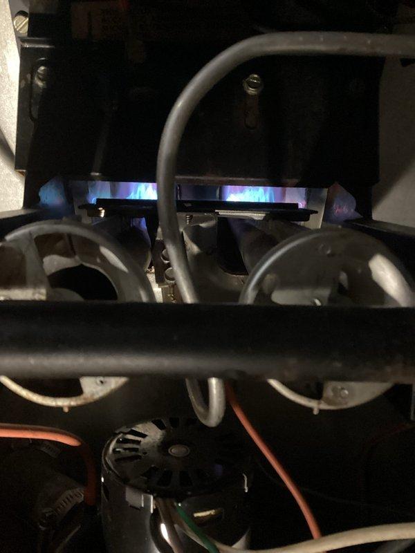 Performed scheduled furnace tune-up on 1983 model. System running but exhibiting short cycling after approximately 5 minutes due to limit switch activation. Diagnostics revealed severely plugged secondary heat exchanger, dirty blower wheel with worn bearings, and oversized blower motor capacitor (7.5μF rated, measuring 9.1μF). Recommended system evaluation by advisor before proceeding with necessary repairs including blower wheel cleaning, secondary heat exchanger cleaning, and blower motor replacement.