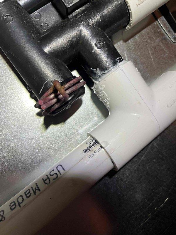 Responded to service call for condensate leak on customer's furnace. Identified the source of the leak at the PVC pipe connecting the condensate trap to the pump, where silicone sealant had not been applied completely around the connection. Removed the pipe, reapplied silicone properly around the entire connection, and confirmed no further leakage after repair.