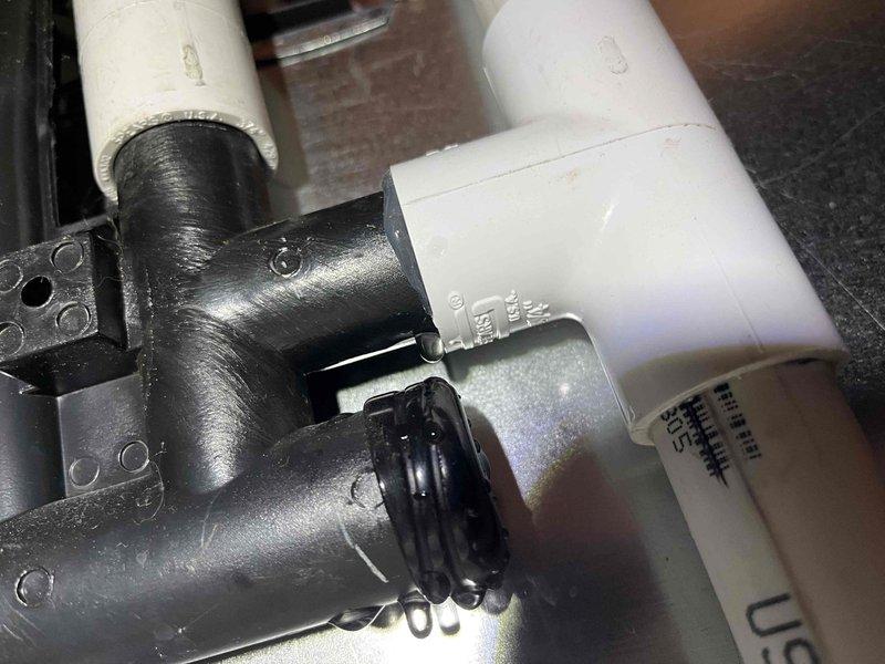Responded to service call for condensate leak on customer's furnace. Identified the source of the leak at the PVC pipe connecting the condensate trap to the pump, where silicone sealant had not been applied completely around the connection. Removed the pipe, reapplied silicone properly around the entire connection, and confirmed no further leakage after repair.