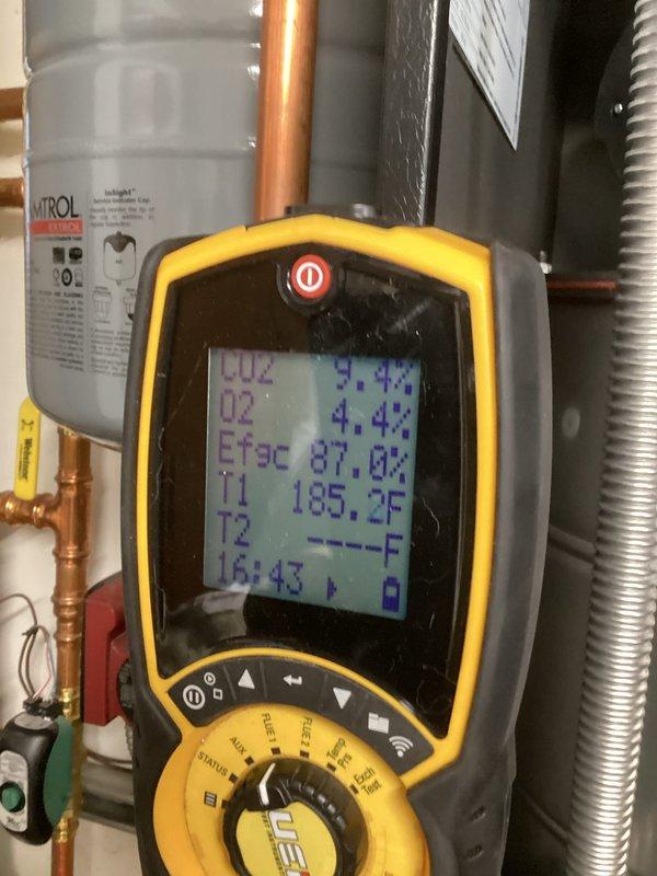 Performed comprehensive tune-up on high efficiency boiler system with indirect tank. Conducted operational inspection including pumps, zone valves, combustion air, and heat exchanger. Cleaned ignitor and increased tank temperature for improved water temperature maintenance. Diagnostic testing confirmed proper operation with supply temperature at 158°F, return at 153°F, and combustion analysis showing CO2 at 9.4% with 87.0% efficiency.