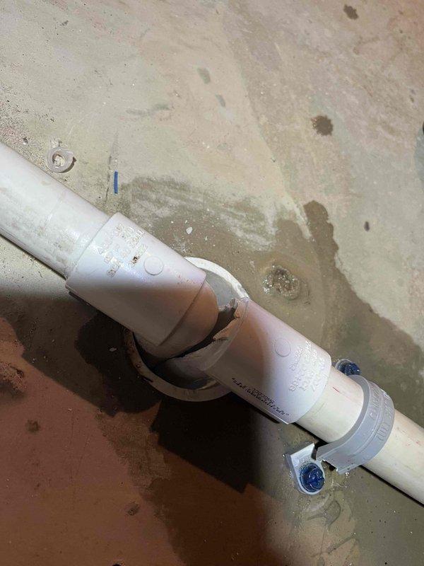 Responded to warranty service call for condensate drainage issue on newly installed furnace. Diagnosed water leak originating from condensate line where water was rolling back from drain due to improper fit. Modified the elbow fitting with tin snips to properly fit the small floor drain, then glued it in place to ensure correct drainage path. Cleaned up accumulated water from the floor.