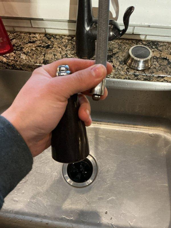 Responded to emergency water leak in basement mechanical room originating from kitchen sink. Discovered kitchen faucet head was coming apart causing significant leakage. Cleaned clogged drain in master bathroom sink and identified leaking tank T in basement water treatment system. Advised customer that tank T repair would require follow-up appointment.