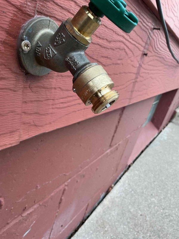 Responded to inspection correction regarding improper backflow prevention. Installed vacuum breaker assembly on exterior hose bib to bring faucet up to code compliance. Completed installation and verified proper functioning of new backflow prevention device.