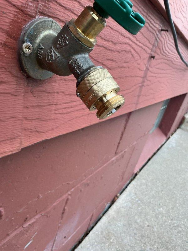 Responded to inspection correction regarding improper backflow prevention. Installed vacuum breaker assembly on exterior hose bib to bring faucet up to code compliance. Completed installation and verified proper functioning of new backflow prevention device.