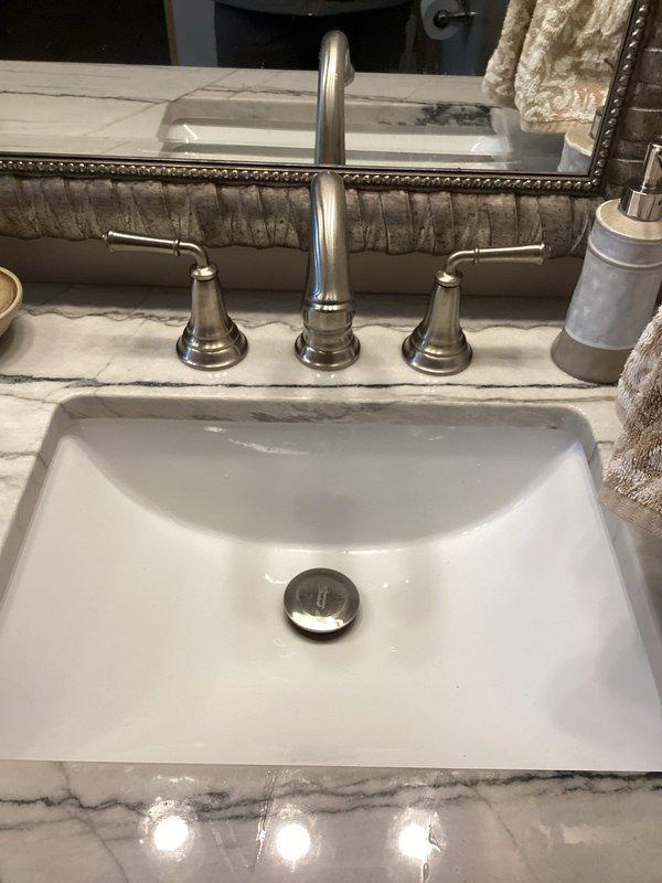 Responded to service call for bathroom sink with non-functioning pop-up drain and humidifier solenoid valve issue. Diagnosed faulty drain mechanism in undermount rectangular sink and provided client with replacement options. Also inspected humidifier solenoid valve, confirmed it was not activating properly, and prepared estimate for replacement parts and labor to resolve both issues.