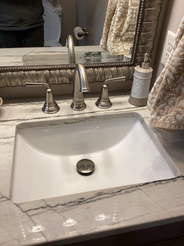 Responded to service call for bathroom sink with non-functioning pop-up drain and humidifier solenoid valve issue. Diagnosed faulty drain mechanism in undermount rectangular sink and provided client with replacement options. Also inspected humidifier solenoid valve, confirmed it was not activating properly, and prepared estimate for replacement parts and labor to resolve both issues.