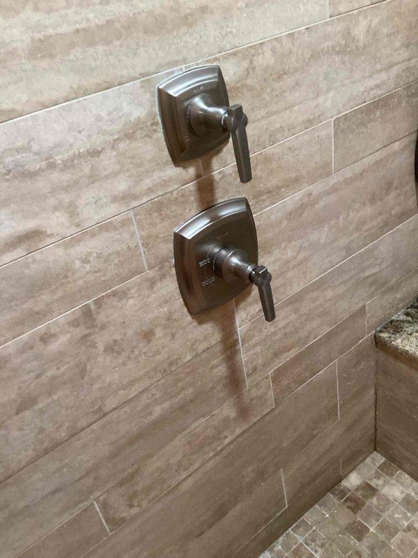 Performed faucet rebuild service with manufacturer replacement cartridge for standard brand bathroom fixtures. Successfully completed the repair on both the shower control system with dual lever handles and the three-piece bathroom sink faucet per the approved estimate. All components were tested for proper function and leak-free operation after installation.