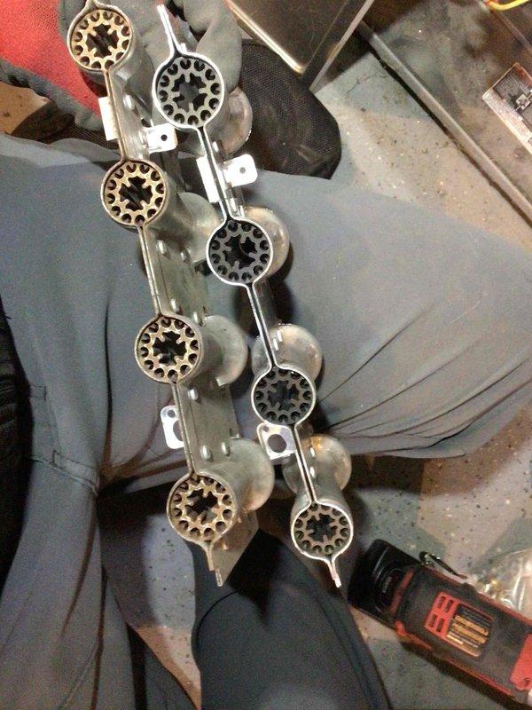 Responded to service call to replace faulty combustion components. Successfully removed and installed new draft combustion inducer assembly and multiple main burners. After installation, system was fully tested and confirmed to be operating properly. Customer was already aware of unrelated plumbing issue (bathroom pipe dripping above furnace).