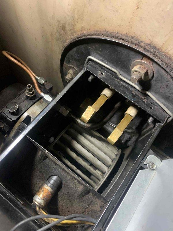 Responded to customer concerns regarding CO2 and smoke from furnace making intermittent rumbling noises. Performed comprehensive inspection of furnace system including visual examination of heat exchanger, electrodes and nozzle. Reconnected flue stack and sealed the chimney connection point to ensure proper venting. Verified ignition system functioning correctly with no delays in ignition sequence.