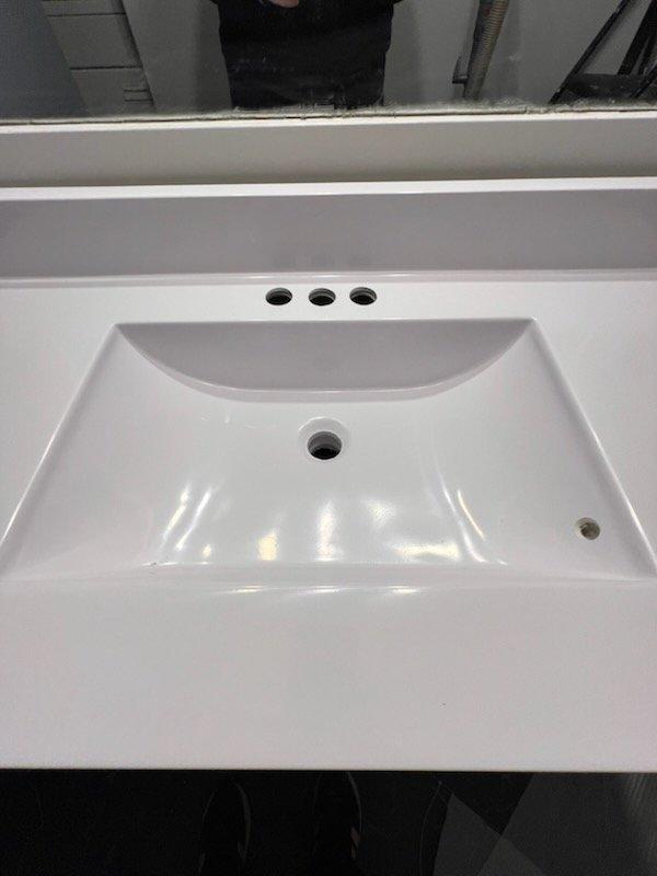 Completed installation of new P-trap assembly and supply lines for bathroom vanity sink during home remodel. Configured black PVC P-trap with proper connections to existing drain line and installed braided metal supply lines to support new faucet hardware. Final inspection confirmed proper drainage and no leaks.