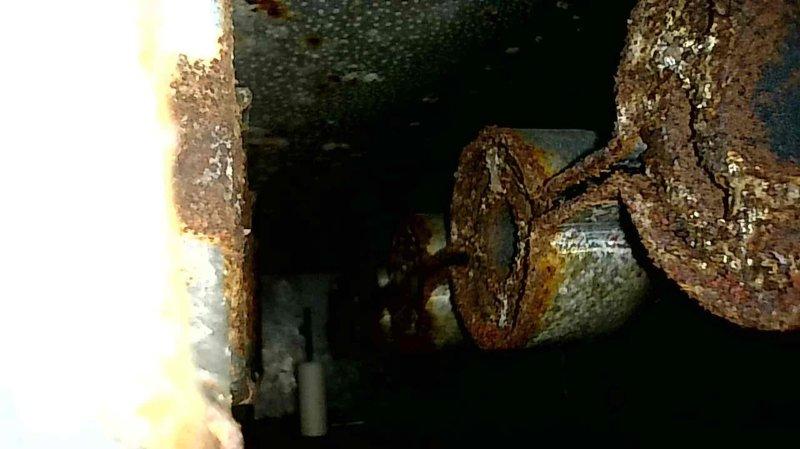 Performed scheduled maintenance on gas furnace including comprehensive tune-up. Inspected heat exchanger for defects, removed and cleaned burners, cleaned condensate line and flame sensor, and verified proper furnace operation. Documented significant rust on plumbing components and frost buildup on insulated ductwork that may require future attention.