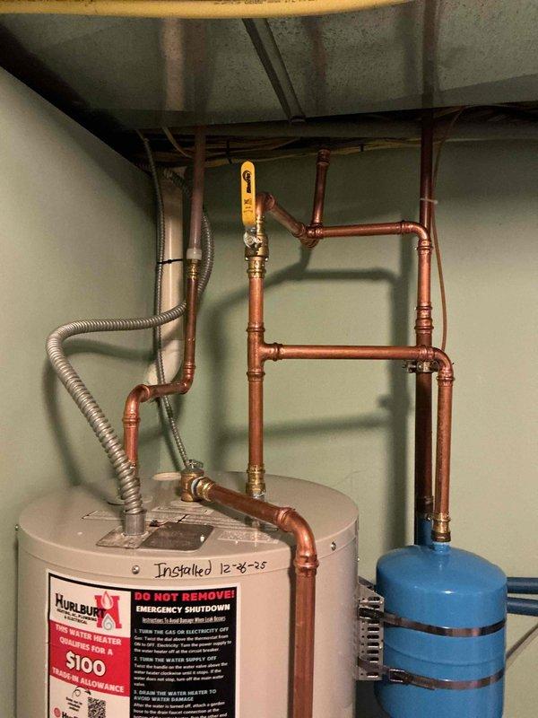 Replaced 16-year-old Bradford White electric water heater due to a faulty lower heating element causing inefficient heating with only 4-5 minutes of hot water. New unit installed with proper connections to existing copper plumbing system and expansion tanks, restoring full hot water capacity to the home.