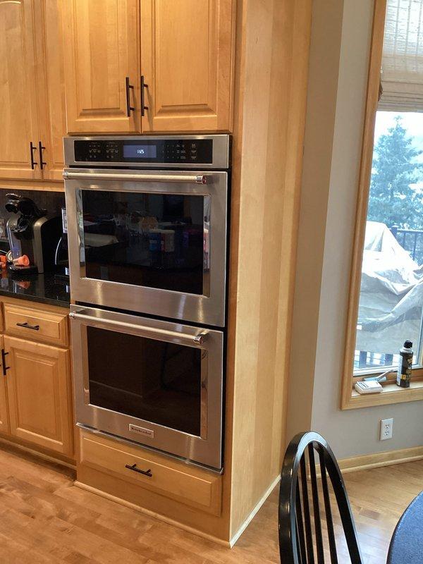 Investigated and repaired a kitchen drain pipe leak that was affecting the basement area. Upon inspection, discovered significant water damage to wooden structural components behind a built-in oven cabinet which homeowner had prepared for access. Identified the leak source in the drain line that activates when kitchen sink and upstairs bathroom fixtures are used, and completed necessary repairs to resolve the issue.