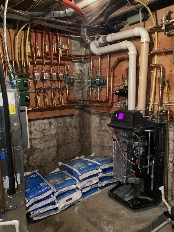 Responded to no-heat call for a boiler that had repeatedly shut off on high temperature safety limit. Observed system operation through both domestic hot water and fan coil heating cycles, confirming proper modulation and temperature control. Adjusted target temperature from 190°F to 185°F to prevent overshooting the 200°F limit. Noted main pump vibration and potential issues with domestic water pump flow, though system was functioning properly at time of departure.