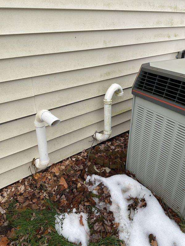 Responded to a call for a York furnace with reported intermittent operation and error codes indicating pressure switch issues. Customer mentioned seeing red lights flashing for pressure switch air. Upon arrival, observed normal amber two-flash operation with call for heat. Removed pressure switch tubing and drain tubing, discovered plugged drain line from flue pipe with no condensate draining from main tube. Cleaned main line by blowing out accumulated debris and cleared flue pipe drain tube multiple times. System operation improved after maintenance.