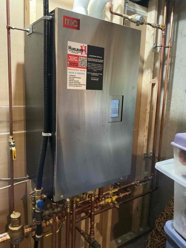 Responded to service call for IBC boiler CK199 reporting high vent limit error code and no hot water. Inspected venting system which showed proper condition, slope and clear termination. Diagnostic testing included running hot water for extended period while monitoring stack temperature, which remained below 127°F. Verified proper operation of exhaust temperature sensor, condensate drainage system, and central heating functionality. No current operational issues detected; likely caused by heavy hot water demand. Instructed customer on proper boiler reset procedure.