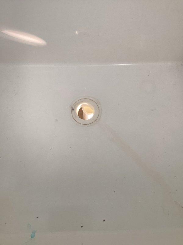 Responded to service call for a broken plastic strainer in a laundry tub that was leaking at the base. Upon inspection, found the fiberglass laundry tub sink damaged beyond repair at its base. Replaced the entire laundry basket assembly with new components and verified proper drainage with no leaks before completing the job.