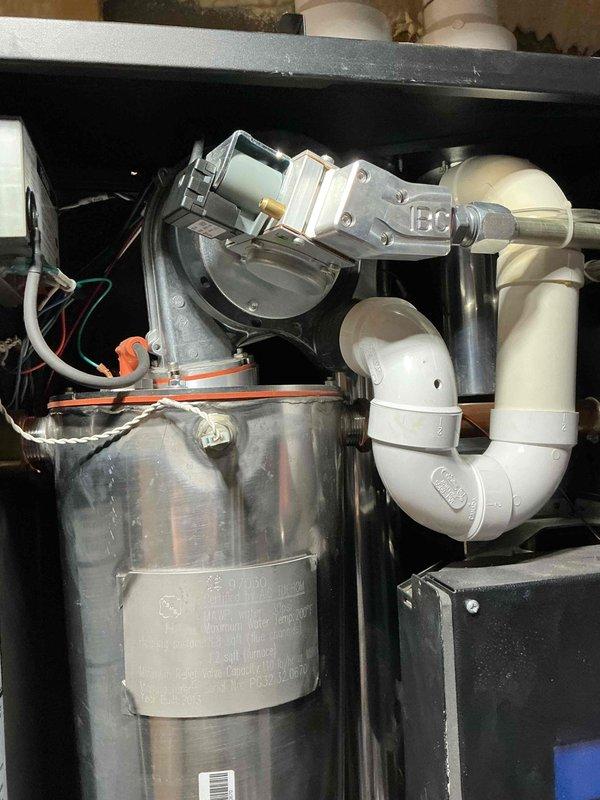 Performed tune-up service on 12-year-old IBC boiler. Removed igniter to inspect heat exchanger, finding significant scale buildup and rust on inner walls. Determined igniter is worn and requires replacement. Discussed options with customer including cleaning (with risk of damage due to existing rust), heat exchanger replacement, or full boiler replacement. Customer elected to schedule follow-up consultation with service advisor.