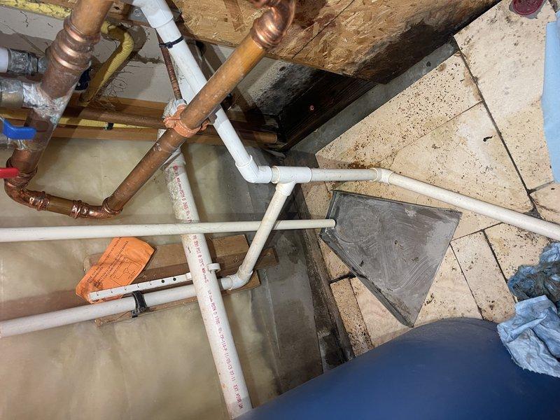 Responded to a no-heat service call for an older boiler system. Upon inspection, discovered a condensate cup that wasn't properly tightened, causing ongoing leakage since installation. Tightened the component to stop the active leak, cleaned the affected floor area, and noted some black organic growth on the back wall which customer acknowledged. Advised customer to periodically check the area for any future leakage issues.