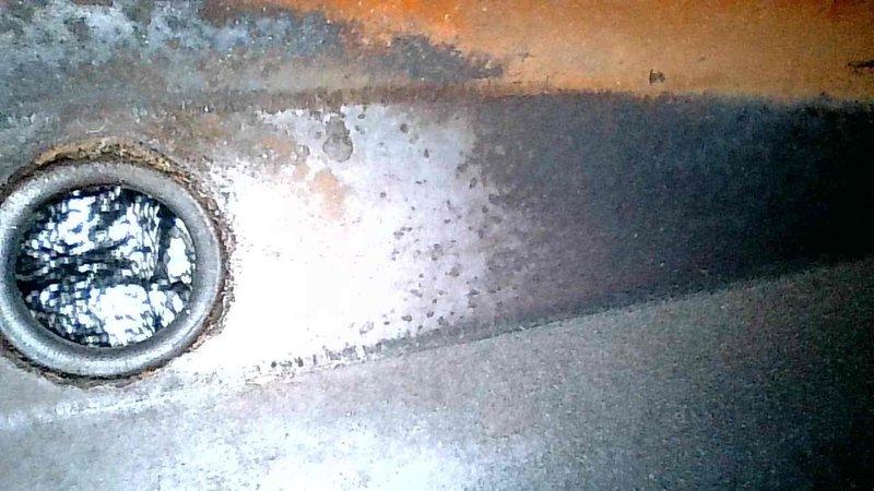 Responded to no heat call for aging furnace (10+ years). Inspection revealed a severely cracked heat exchanger with flames rolling back upon blower activation and a large hole in the secondary header box. Unit was immediately tagged out of service as unsafe to operate due to carbon monoxide hazard. Customer advised that complete furnace replacement is required.