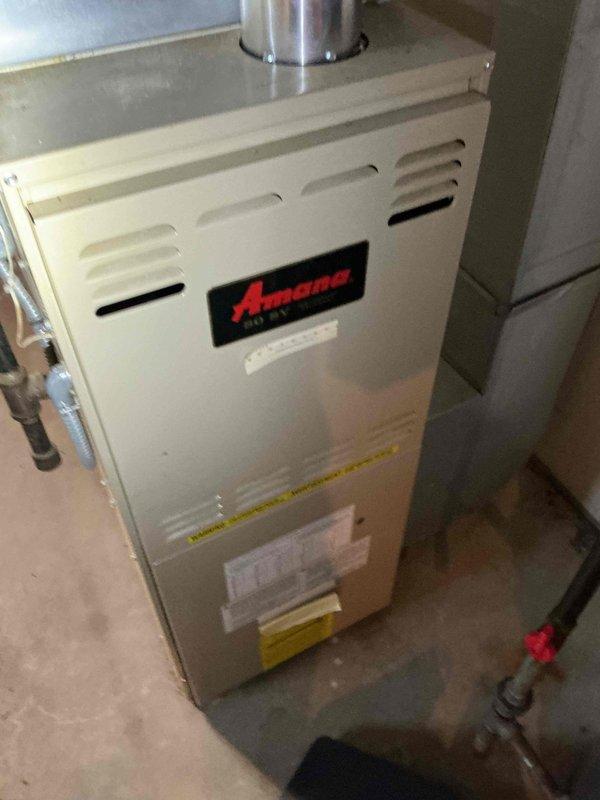 Responded to a no heat call for 25-year-old Amana furnace. Diagnosed tripped limit switch due to restricted airflow from severely clogged filter. Replaced filter and reset system, restoring normal heating operation. Unit functioning properly upon departure.