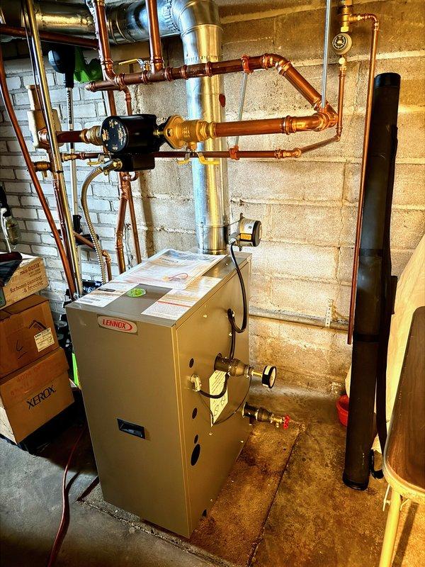 Responded to no heat complaint on recently installed Lennox boiler. Upon inspection, observed water dripping from chimney pipe line. Opened unit to examine gas valve assembly and insulation. Performed system operation test and restored proper heating function.
