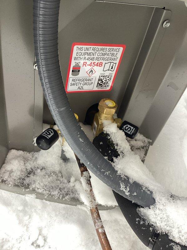 Responded to warranty service inspection failure. Installed required locking refrigerant caps on an R-454B compatible HVAC unit that showed significant frost/ice buildup around lower components and connections. Documented installation with photos for submission to Ashly.