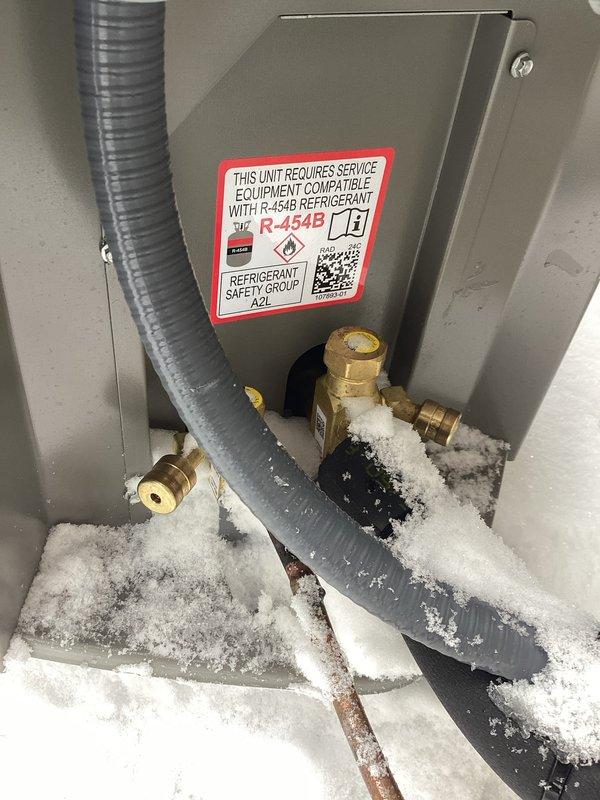 Responded to warranty service inspection failure. Installed required locking refrigerant caps on an R-454B compatible HVAC unit that showed significant frost/ice buildup around lower components and connections. Documented installation with photos for submission to Ashly.