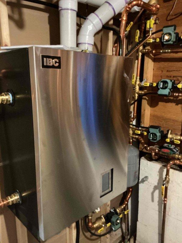 Responded to warranty service call for recently installed IBC boiler (20 days old). Customer reported insufficient hot water supply and inadequate heating on main floor despite thermostat settings. Diagnosed circulation issue in water heater zone and increased pump speed to resolve hot water depletion problem that was occurring after approximately 20 minutes of use.