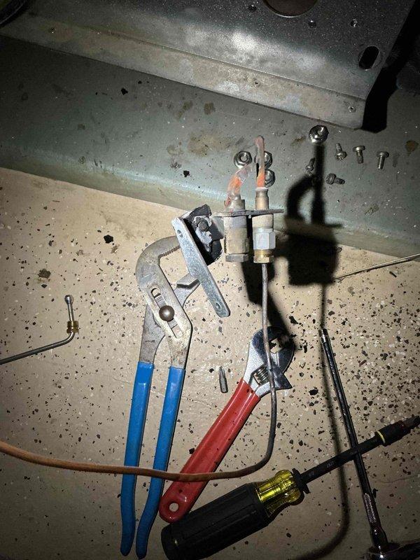 Responded to no-heat call for 20+ year old Buderus boiler with pilot light failure. Diagnosed broken pilot tube causing improper gas distribution and identified significant soot accumulation on burners and pilot assembly. Attempted to source replacement standing pilot assembly but manufacturer only offers intermittent pilot version. Universal assembly installation was unsuccessful due to incompatible pilot tube fittings. Homeowners opted for service advisor consultation.