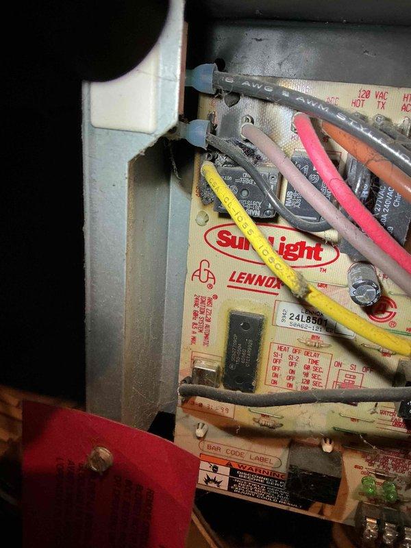 Diagnosed 26-year-old Lennox furnace with intermittent heating issues. Found weak flame sensor which was cleaned to restore ignition, but subsequently identified severe burning damage around the blower relay and wiring on the SureLight control board. Visual inspection of burner assembly showed proper combustion with blue flames, however blower motor failed to activate. Recommended replacement parts due to age of unit and potential board/blower motor failure.