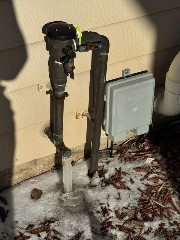 Responded to service call for leaking irrigation system shutoff valve. Diagnosed active leak at exterior irrigation access point with visible dripping and frost formation at the base. Successfully replaced the faulty valve, resolving the water leak while maintaining uninterrupted water service to the residence.