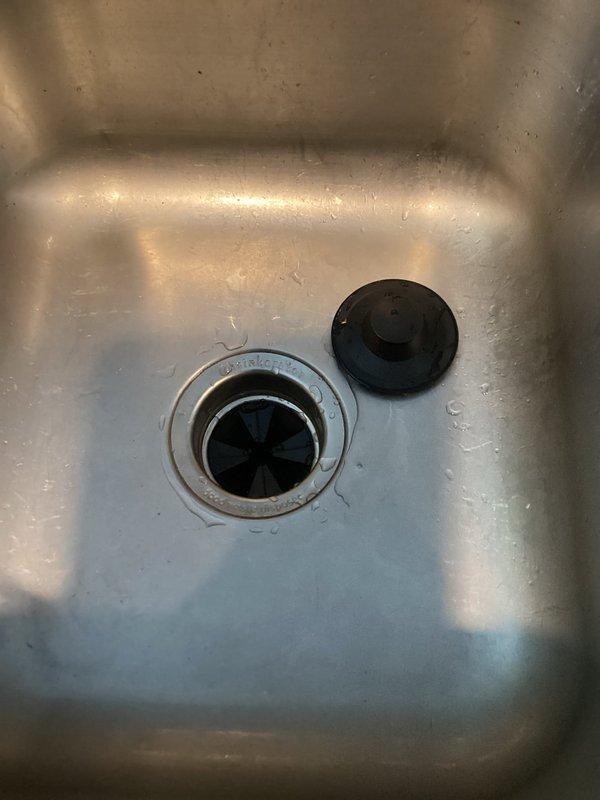 Responded to service call for non-functioning kitchen sink and garbage disposal unit. Upon inspection, determined garbage disposal was inoperable and leaking from housing. Removed existing damaged disposal unit and installed new replacement disposal. Tested system for proper operation and drainage after installation; sink now draining properly with functional disposal unit.