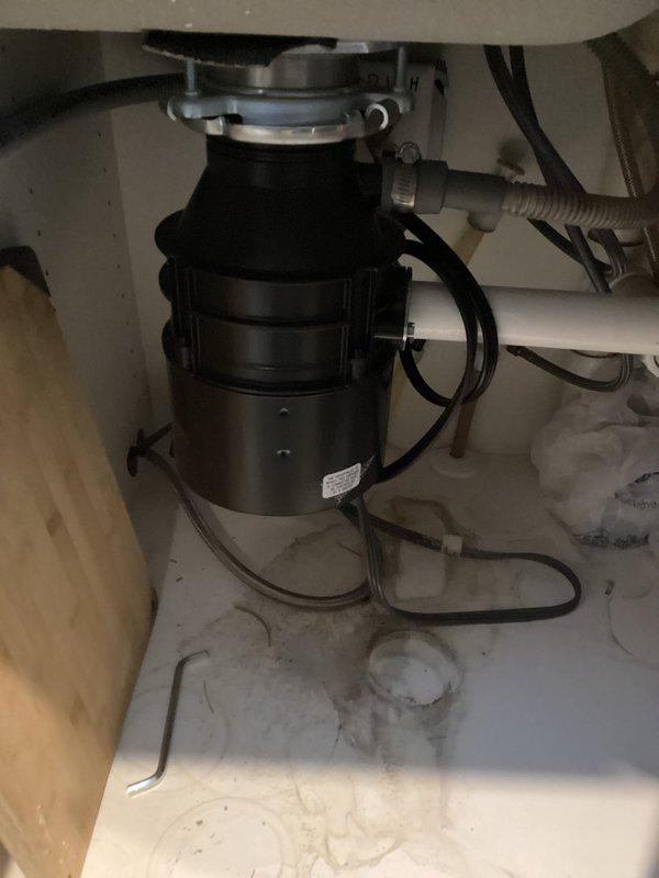 Responded to service call for non-functioning kitchen sink and garbage disposal unit. Upon inspection, determined garbage disposal was inoperable and leaking from housing. Removed existing damaged disposal unit and installed new replacement disposal. Tested system for proper operation and drainage after installation; sink now draining properly with functional disposal unit.