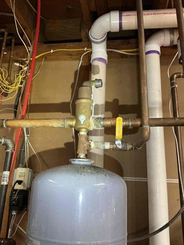 Serviced 12-year-old boiler with multiple failure points causing no heat condition. Diagnosed low pressure, plugged air separator vent, worn ignition assembly, and buildup in heat exchanger. Performed system recharge to restore proper pressure, cleaned heat exchanger to improve efficiency, serviced ignition components, and replaced defective air separator. System now operational with proper pressure maintained by functioning expansion tank and air separator assembly.