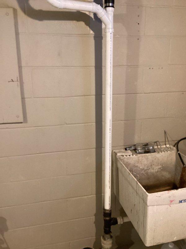 Responded to call for kitchen sink leak causing basement damage. Upon inspection, found rotted sink arm requiring replacement. Completed repiping of kitchen sink drain system, installing new PVC drain assembly with proper P-trap and vertical waste line that connects to the main drainage system. Verified proper operation with no leaks.