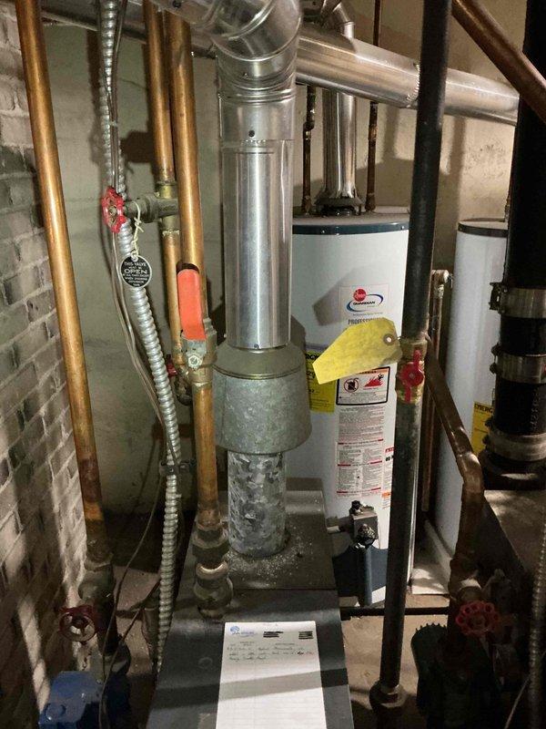 Diagnosed no heat issue on 20+ year old Weil McLain boiler with pilot light failure. Replaced faulty thermocouple after cleaning attempt was unsuccessful. Identified additional issues including leaking gate valve at water fill, faulty pressure relief valve, and potential heat exchanger leak evidenced by yellow nodules. System restored to operation temporarily; service advisor appointment scheduled for comprehensive evaluation.