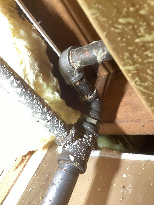 Identified and repaired gas leak on the main supply line at fitting after the regulator. Replaced several black iron fittings and section of pipe to resolve the issue. System tested for leaks after repair with gas supply verified to stove and furnace, pilot relit on water heater, and normal operation confirmed.